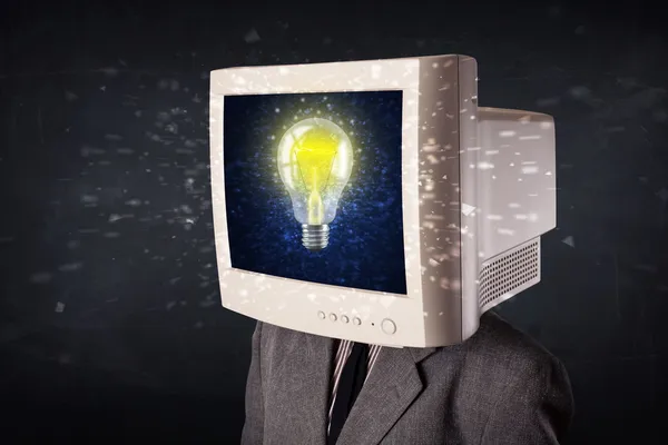 Business man with a pc monitor head and idea light bulb in the d — Stock Photo, Image