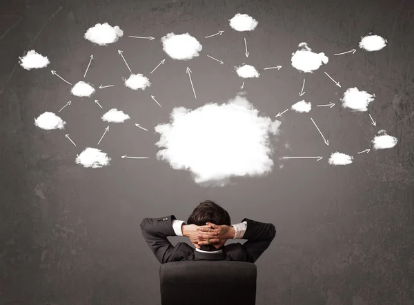 Businessman sitting with cloud technology above his head — Stock Photo, Image