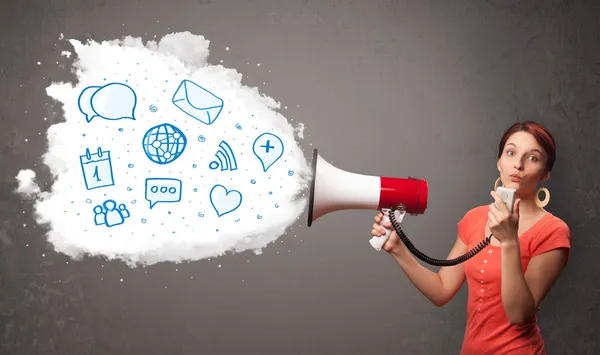 Woman shouting into loudspeaker and modern blue icons and symbol — Stock Photo, Image