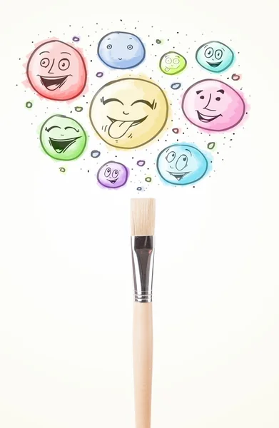 Smiley faces coming out of paintbrush — Stock Photo, Image