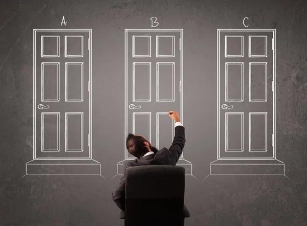 Businessman choosing the right door — Stock Photo, Image