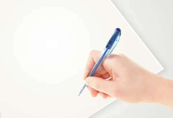 Hand writing on plain empty white paper copy space — Stock Photo, Image