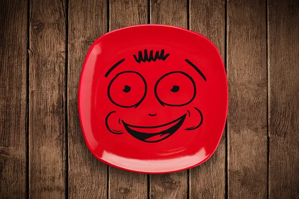 Szczęśliwy uśmiech kreskówki twarz na kolorowym talerzu — Zdjęcie stockowe
