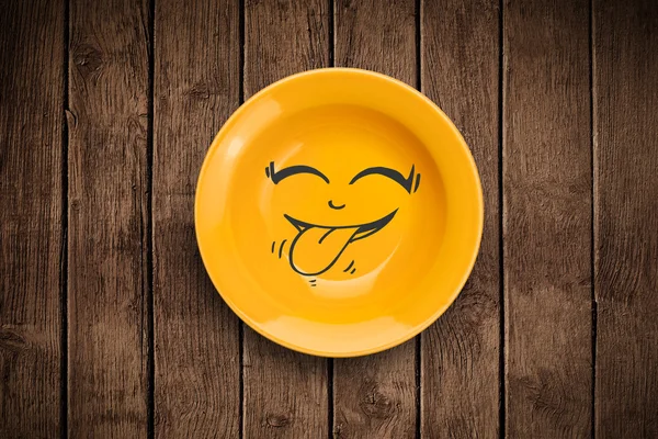 Happy smiley cartoon face on colorful dish plate — Stock Photo, Image