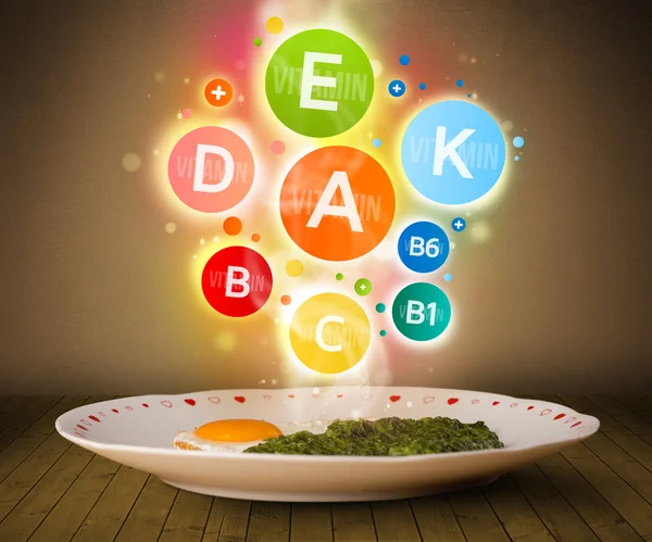 Food plate with delicious meal and healthy vitamin symbols — Stock Photo, Image