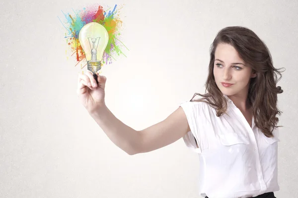 カラフルなスプラッシュでカラフルな電球を描く若い女性 — ストック写真