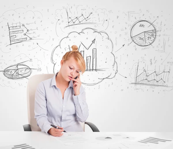 Business woman sitting at table with hand drawn graph charts Stock Picture