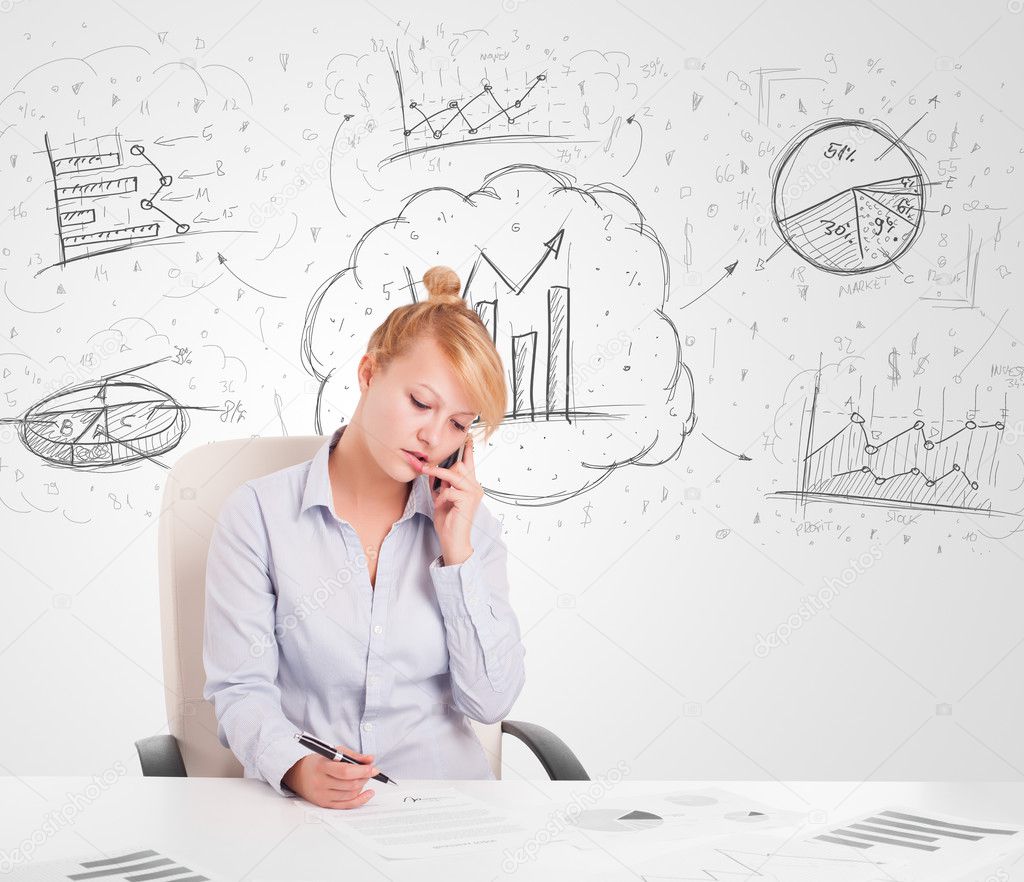 Business woman sitting at table with hand drawn graph charts