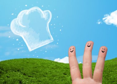 Mutlu gülen yüzlü parmaklar aşçı şapkasının resmine bakıyor.