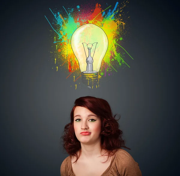 Young woman thinking with lightbulb above her head — Stock Photo, Image