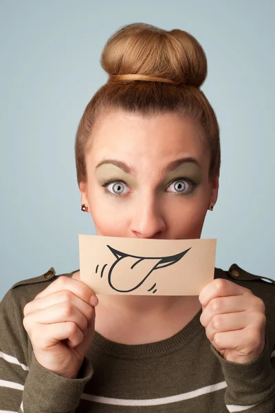 Pretty young girl holding white card with smile drawing — Stock Photo, Image