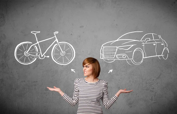 Woman making a choice between bicycle and car — Stock Photo, Image