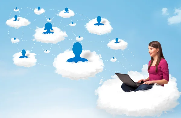 Young woman sitting in cloud with laptop — Stock Photo, Image