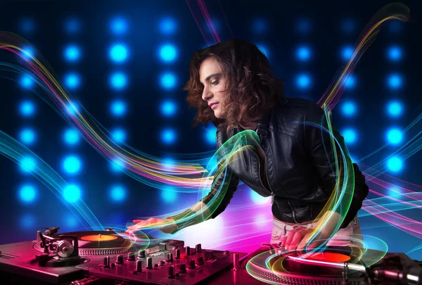 Young Dj girl mixing records with colorful lights — Stock Photo, Image