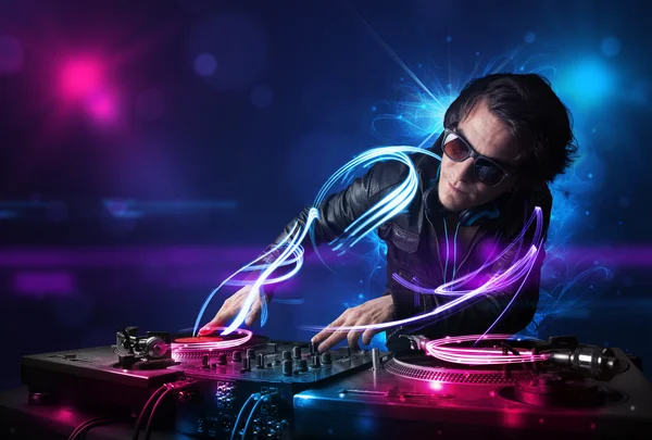 Disc jockey playing music with electro light effects and lights — Stock Photo, Image