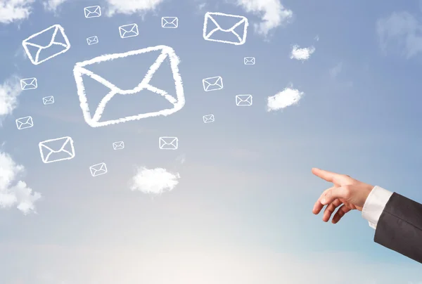 Hand pointing at mail symbol clouds on blue sky — Stock Photo, Image