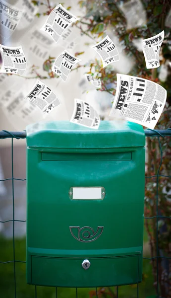 Post box with daily newspapers flying — Stock Photo, Image