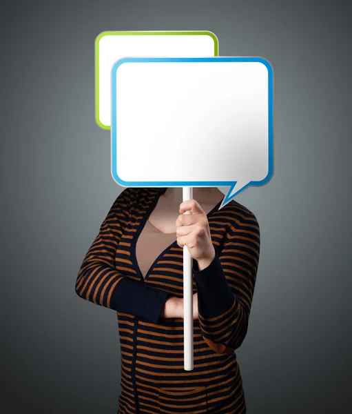 Young woman holding speech bubble — Stock Photo, Image