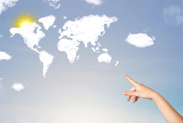 Hand pointing at world clouds and sun on blue sky — Stock Photo, Image