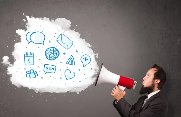 Man shouting into loudspeaker and modern blue icons and symbols — Stock Photo, Image