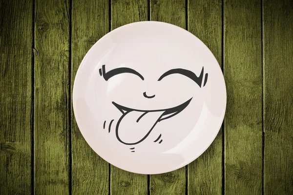 Happy smiley cartoon face on colorful dish plate — Stock Photo, Image