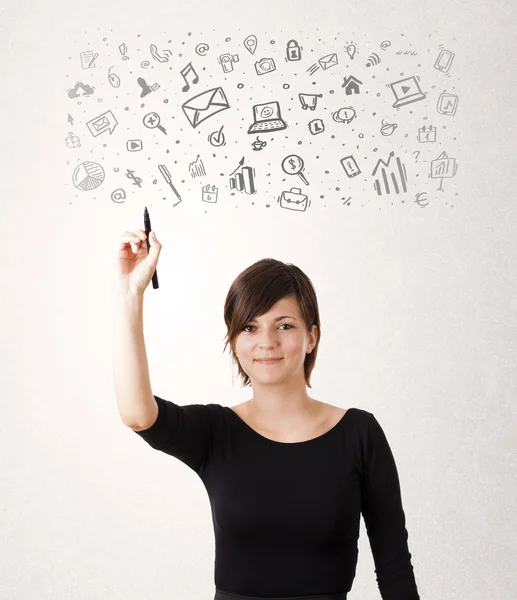 Young woman drawing and sketching icons and symbols — Stock Photo, Image