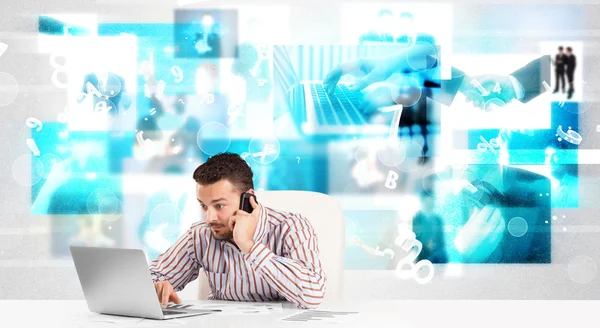 Business person at desk with modern tech images at background — Stock Photo, Image