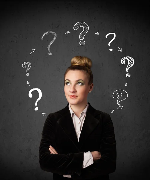 Young woman thinking with question mark circulation around her h — Stock Photo, Image