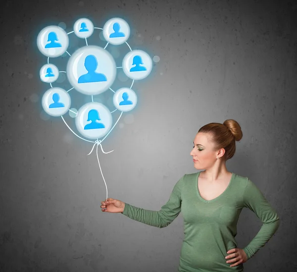 Woman holding social network balloon — Stock Photo, Image