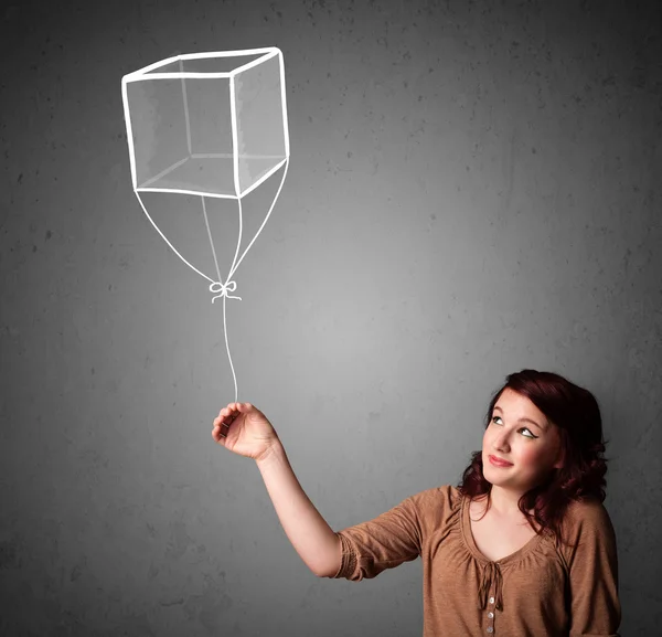 Donna in possesso di un palloncino cubo — Foto Stock