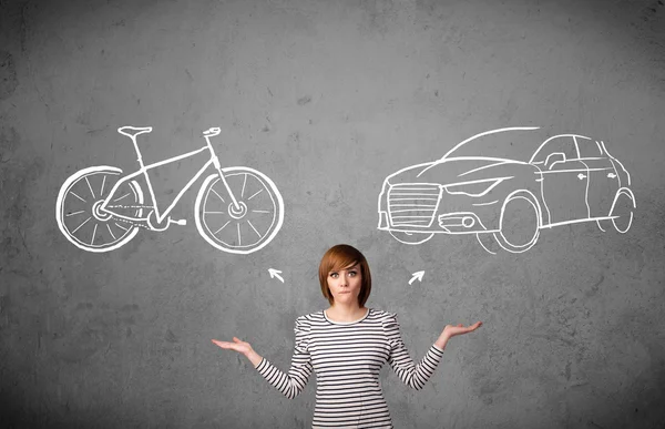 Woman making a choice between bicycle and car — Stock Photo, Image