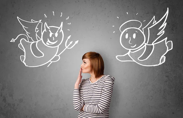 Woman standing between the angel and the devil — Stock Photo, Image