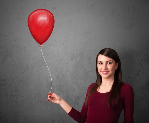 Frau mit rotem Luftballon — Stockfoto