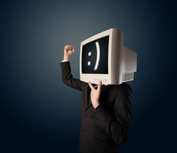 Funny young businessman with a monitor on his head and smiley on — Stock Photo, Image