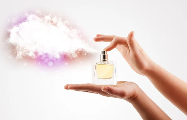 Woman hands spraying colorful cloud — Stock Photo, Image