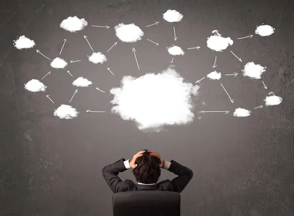 Businessman sitting with cloud technology above his head — Stock Photo, Image