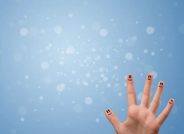 Sorrisos dedo feliz com fundo bokeh azul vazio — Fotografia de Stock