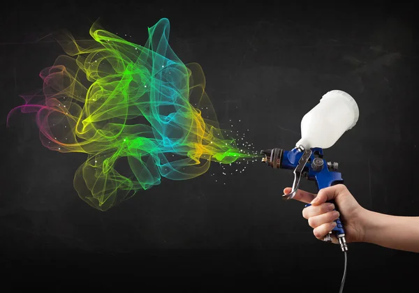 Painter working with airbrush and paints colorful paint — Stock Photo, Image
