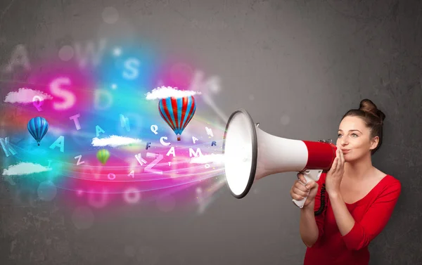 Girl shouting into megaphone and abstract text and balloons come — Stock Photo, Image