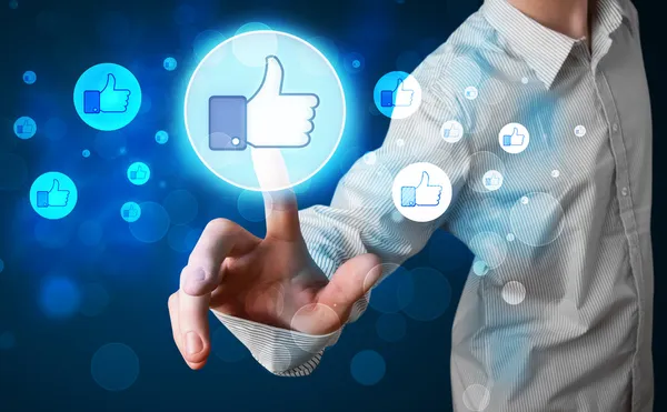 Handsome person pressing thumbs up button on modern social netwo — Stock Photo, Image