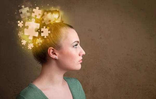 Young person thinking with glowing puzzle mind — Stock Photo, Image