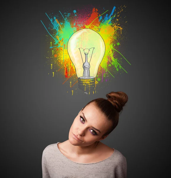 Young woman thinking with lightbulb above her head — Stock Photo, Image