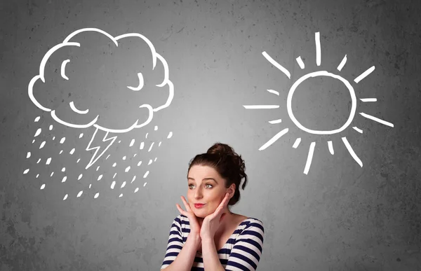 Woman standing between a sun and a rain drawing — Stock Photo, Image