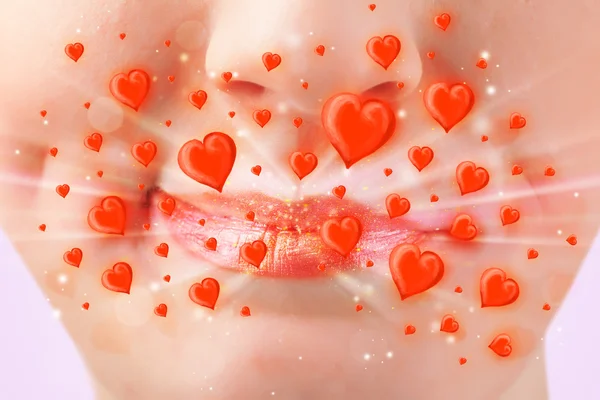 Pretty lady lips with lovely red hearts — Stock Photo, Image