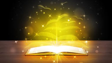 Altından parlak uçan kağıt sayfaları olan açık bir kitap