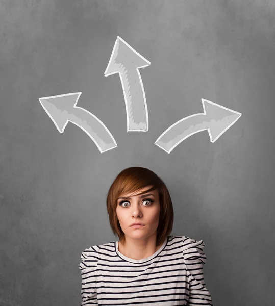 Young woman thinking with arrows above her head — Stock Photo, Image