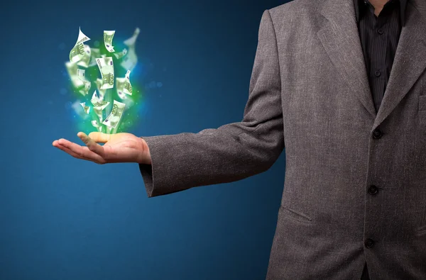 Glowing money in the hand of a businessman — Stock Photo, Image