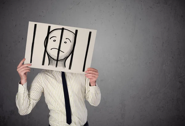 Businessman holding a paper with a prisoner behind the bars on i — Stock Photo, Image