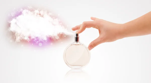 Woman hands spraying colorful cloud — Stock Photo, Image