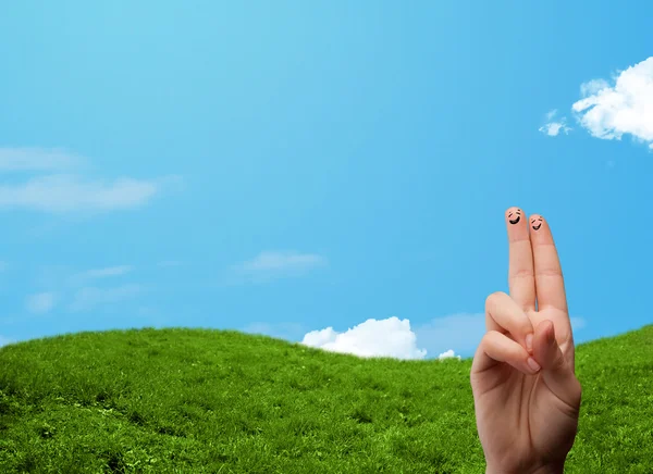 Cheerful finger smileys with landscape scenery at the background — Stock Photo, Image